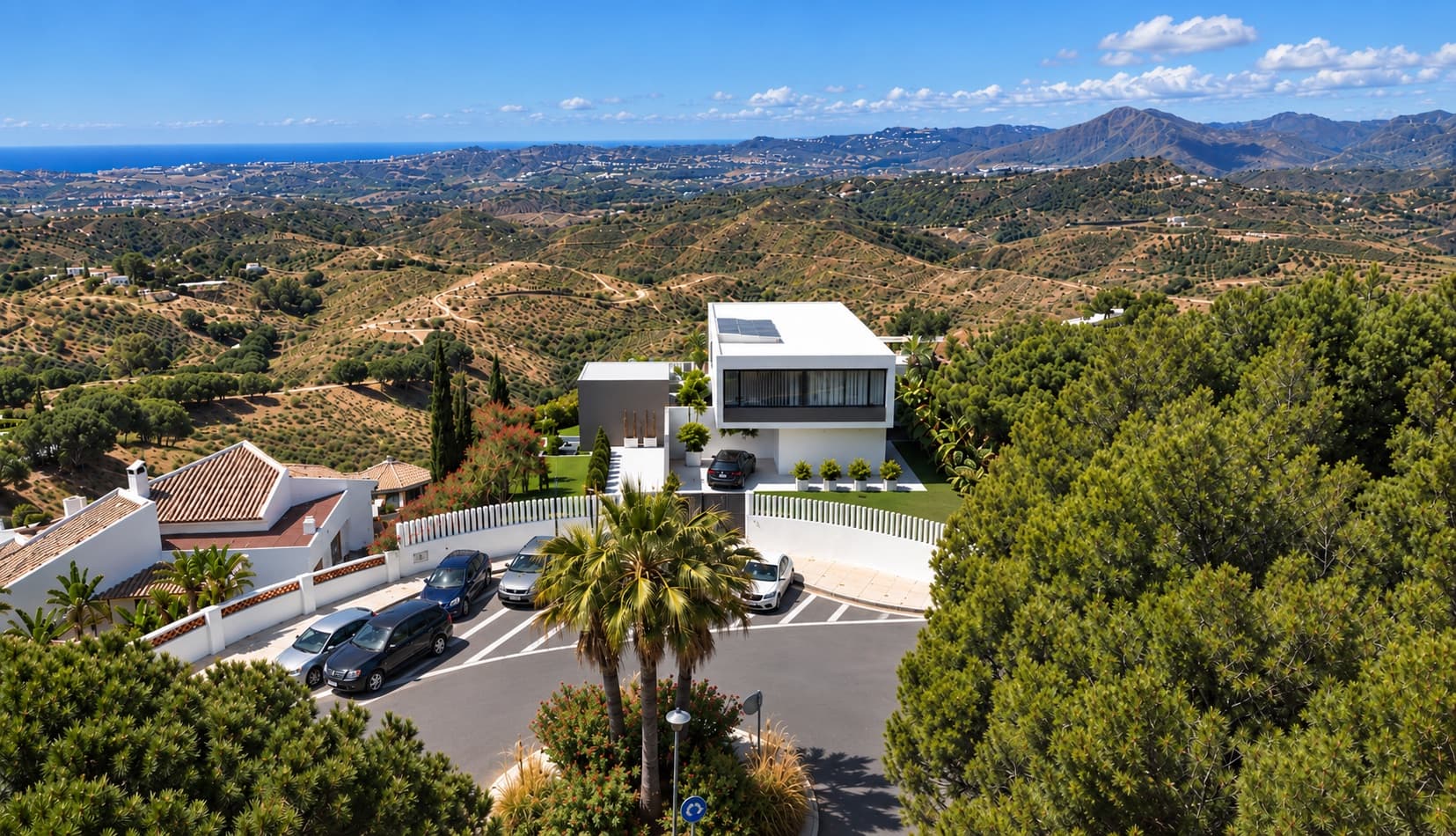 Aerial view of the entrance to Villa Los Pichies with a roundabout and private car park