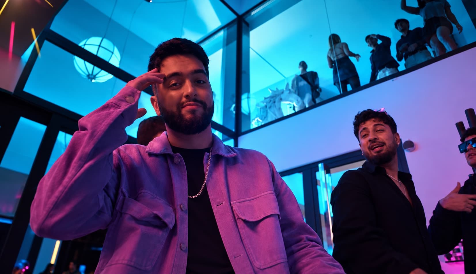 Still from the music video with neon lights in the villa's living room